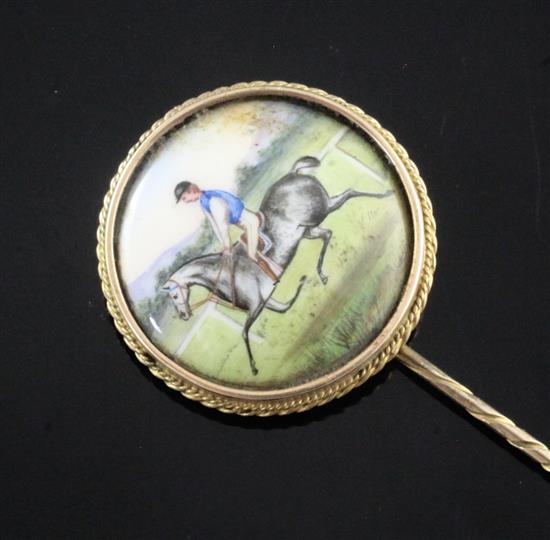 T.E.Shaw (19th C.) a gold mounted enamel tiepin decorated with a horse and jockey Steel Grey 81mm.